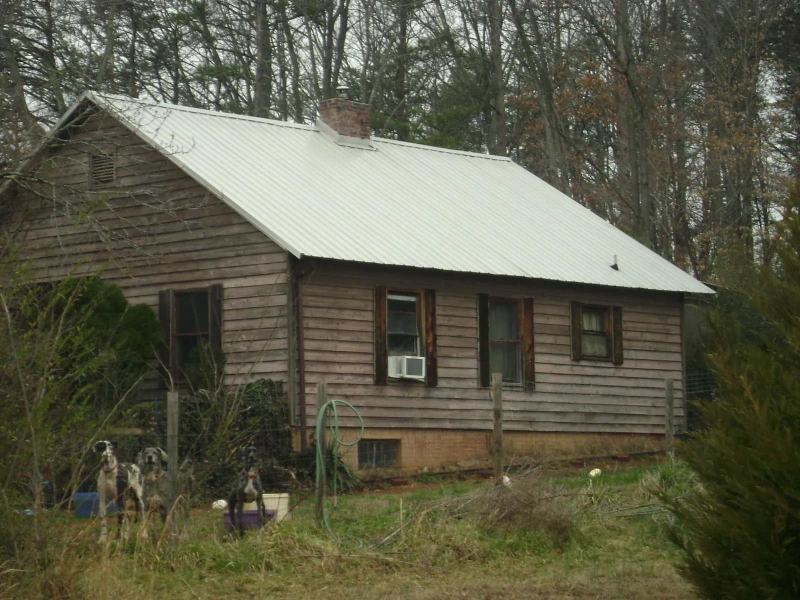 White metal roof on an old wood sided farmhouse, from a Metal Roof Installation job in Maricopa
